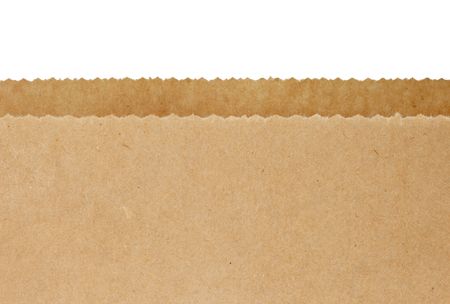 Top serrated edges of an open brown paper bag, over white background.の写真素材