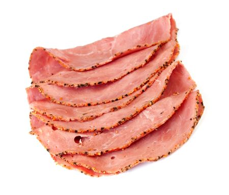 Slices of pastrami, isolated on white background.の写真素材