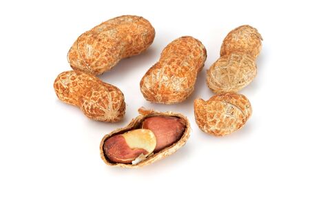 Peanuts, dry roasted in the shell, isolated on white.