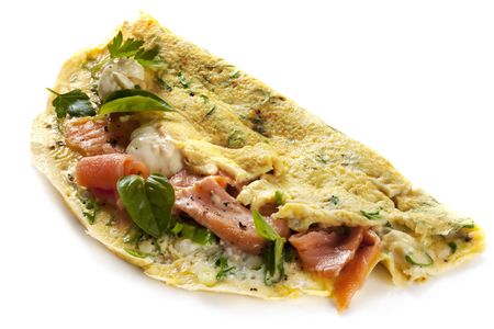 Omelette with smoked salmon, herbs and creme fraiche, isolated on white.の写真素材