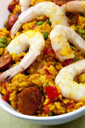 Delicious paella in white serving bowl.の写真素材