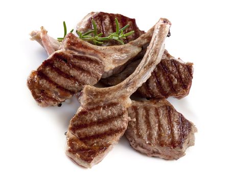 Grilled lamb cutlets with a sprig of rosemary.の写真素材