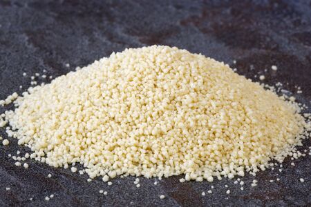 Heap of cous cous, over a stone bench.の写真素材