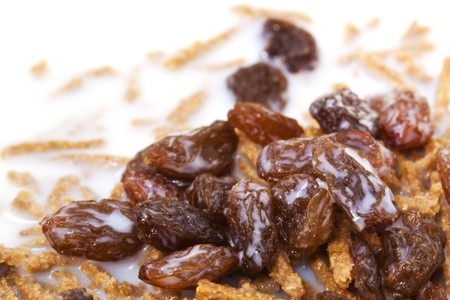 Bran breakfast cereal topped with sultanas and low-fat milk.  Healthy, high-fiber eating.の写真素材