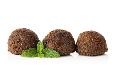 Falafel balls, isolated on white with a sprig of mint.  の写真素材