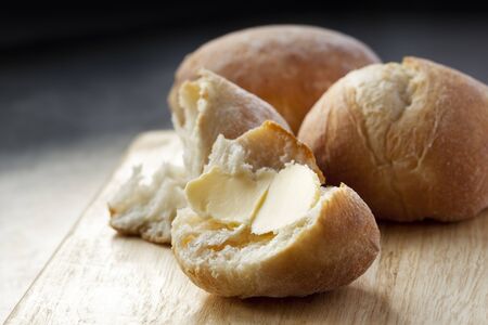 Buttered bread roll.  Lovely and crusty, ready to eat.