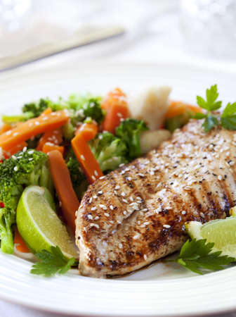 Grilled chicken breast with steamed vegetables.  Delicious, low fat eating.の写真素材