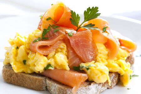 Scrambled eggs with smoked salmon, on sourdough toast.の写真素材
