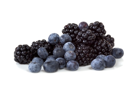 Blackberries and blueberries, isolated on white background.  Fresh berry fruit goodness.の写真素材