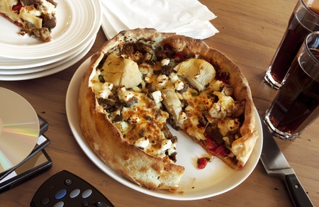 Chicago style deep dish pizza, with cola, settling in for a night of DVDs.の写真素材