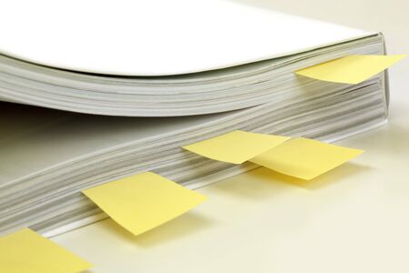 Instruction Manual marked with yellow post-it tags.  Soft focus.