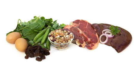Iron-rich foods, including eggs, spinach, peas, beans, red meat, liver, and raisins.  Isolated on white.の写真素材