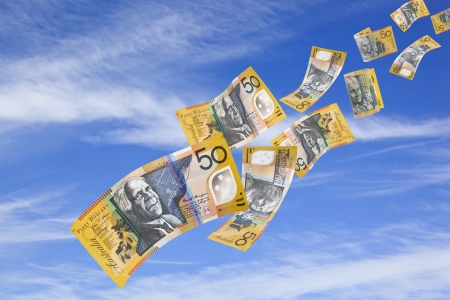 Australian fifty dollar bills falling from a blue sky.の写真素材