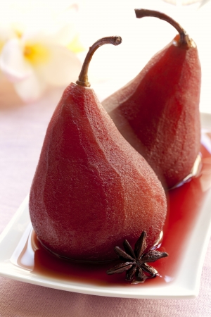 Pears poached in red wine, with star anise.  Delicious beurre bosc variety.の写真素材