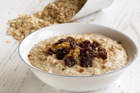 Porridge with walnuts, raisins and brown sugar.  Delicious oatmeal.の写真素材