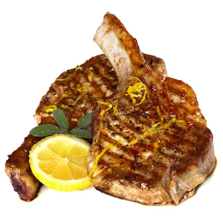 Grilled pork chops with sage and lemon, isolated on white background の写真素材