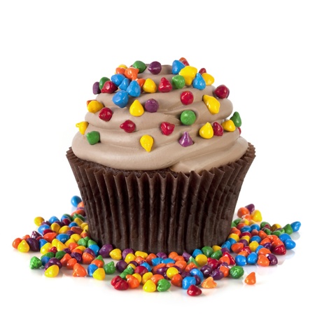 Chocolate cupcake topped with colorful sprinkles.  Isolated on white.の写真素材