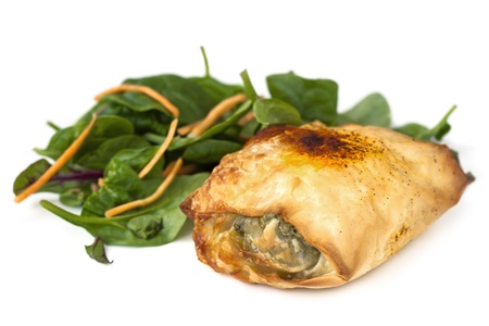 Chicken filo with a spinach salad, isolated on white background.の写真素材