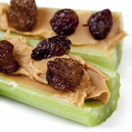 Ants on a log   Celery sticks with peanut butter and raisins   Healthy snacking の写真素材