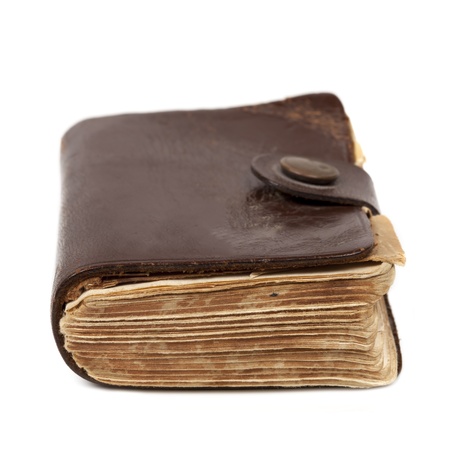 Old brown leatherbound book, isolated on white background の写真素材