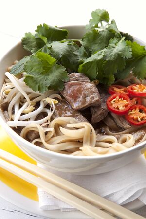 Bowl of Vietnamese beef pho, with chopsticks   Delicious, healthy eating 