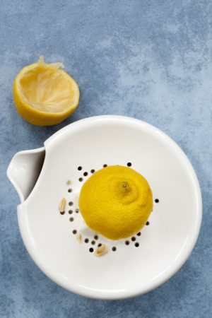 Lemon on white ceramic juicer   Overhead view の写真素材