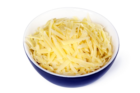 Grated cheddar cheese in small  blue bowl, isolated on white. Clipping path included.の写真素材