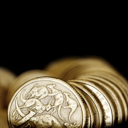 Australian one dollar coins over black background.の写真素材