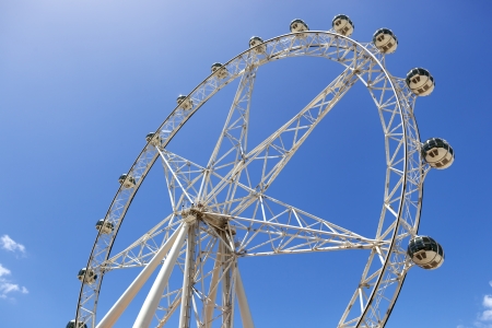 Observation or ferris wheel, against brilliant blue sky.の写真素材
