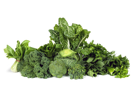 Variety of leafy green vegetables isolated on white background.の写真素材