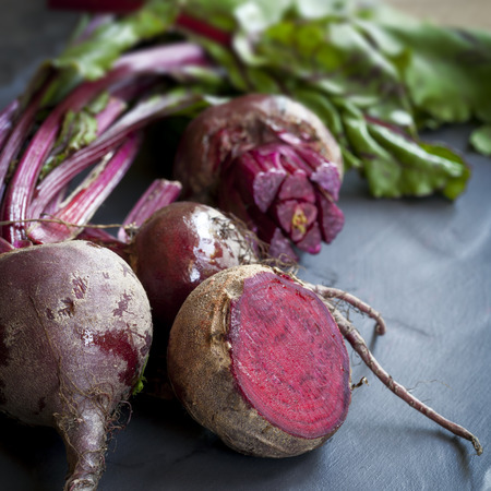 Raw baby beetroot, on dark slate.  の写真素材