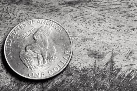 Old silver American dollar coin, over grunge background.