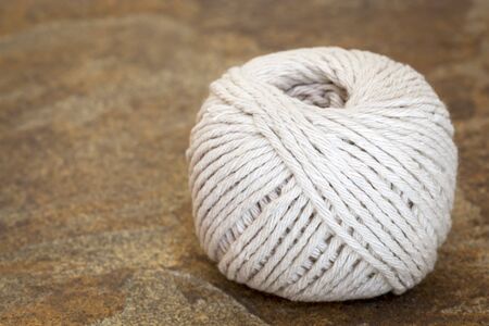 Ball of white string or twine on stone background.の写真素材
