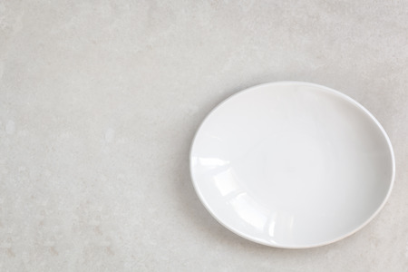 Empty white oval plate on marble.  Top view.の写真素材