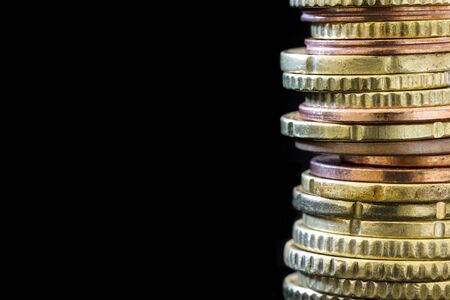 Stack of Euro coins over black.  Finance background with copy space.の写真素材