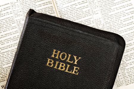 Old Holy Bible over blurred open book.