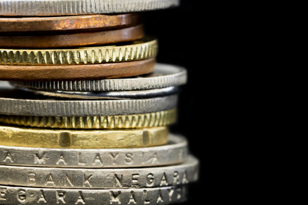 Stack of Malaysian coins over black background.の写真素材