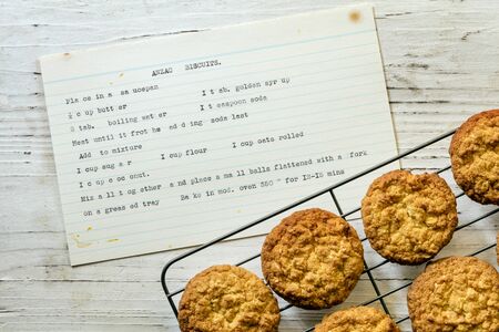 Anzac biscuits on rack with vintage typewritten recipe.  Top view on rustic timber.の写真素材
