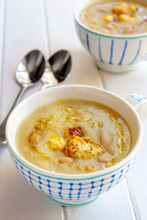 Cauliflower with white bean soup.  Two bowls with spoons, ready to eat.の写真素材