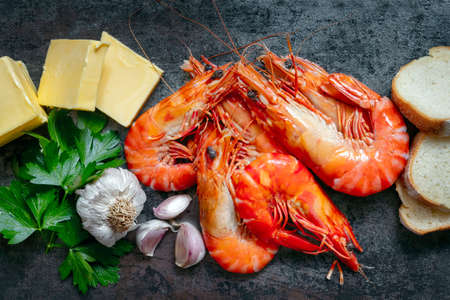 Ingredients for garlis prawns or shrimp, on slate with black background.  Top view.の写真素材