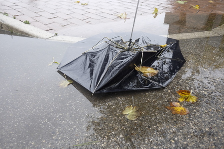 broken umbrella in the puddleの写真素材