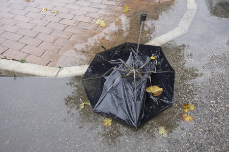 broken umbrella in the puddleの写真素材
