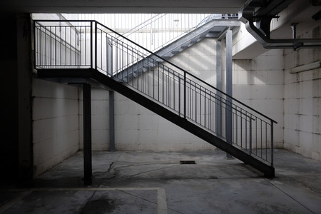 woman on the metallic stairs of the shopping mallの写真素材
