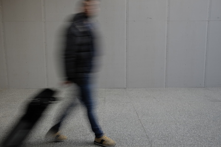 blurry person walking in the airportの写真素材