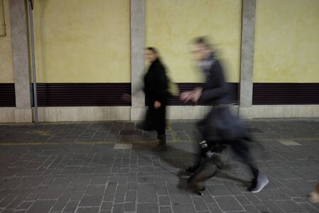 blurry people walking in the city center