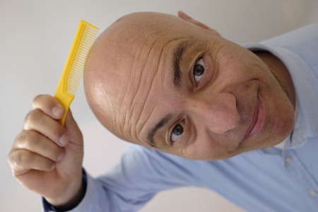 bald man with combの写真素材