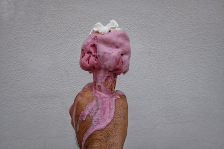 ice cream cone melted in your handの写真素材