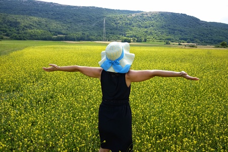 woman with hat in flowery field