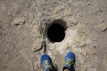 my feet in front of a hole