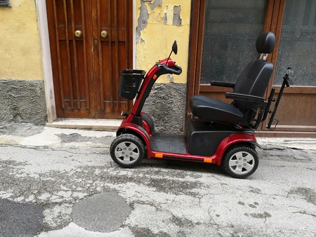 motorized wheelchair parked on the streetの写真素材